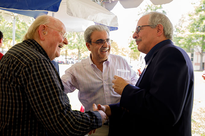 Dean Eskandarian (center) introduces Terry Hufford, Professor Emeritus of Biology, to President LeBlanc (right). (William Atkins)