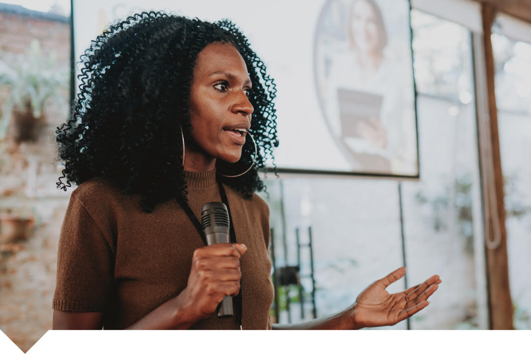 Woman in a classroom engaging with an audience