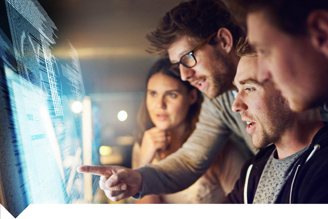 Group of four people, three men and a woman, looking at a computer screen with code