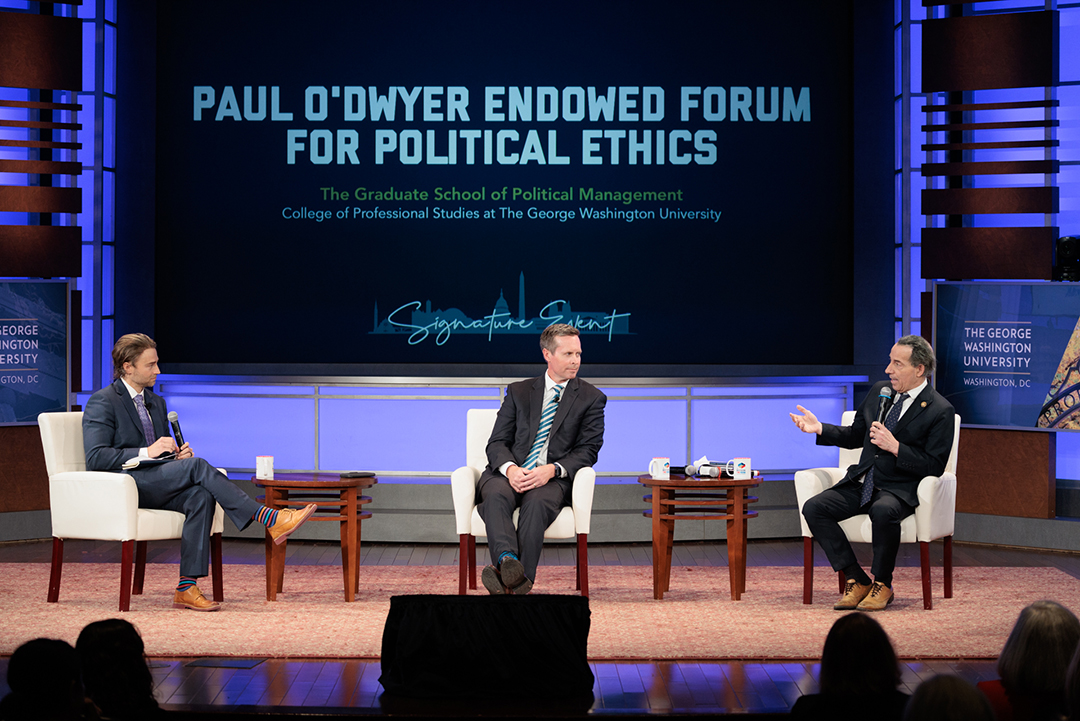 Three men seated on stage and background with large words Paul O'Dwyer Endowed Forum for Political Ethics