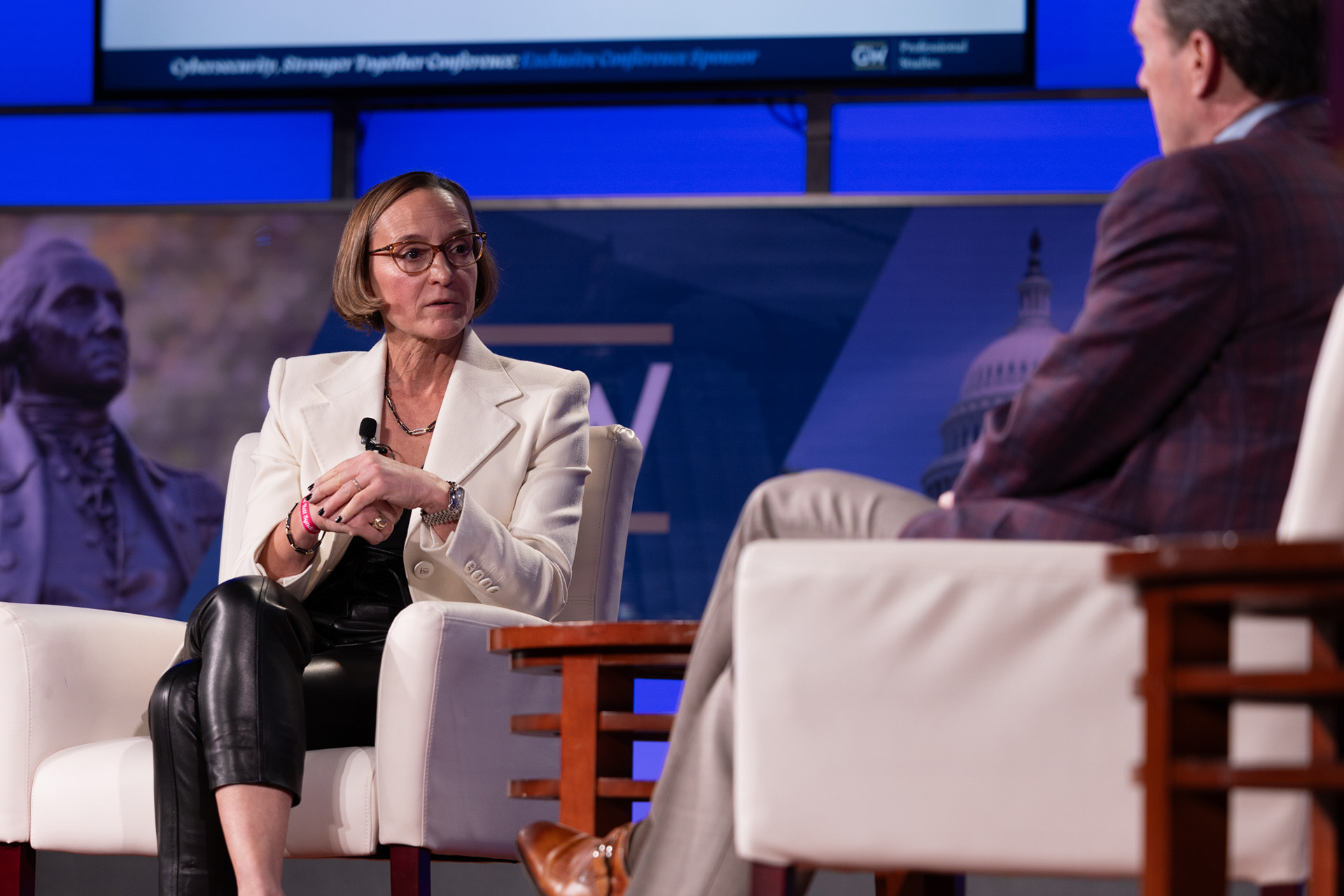 Amy Gilliland sitting onstage in conversation with Roger Cressey