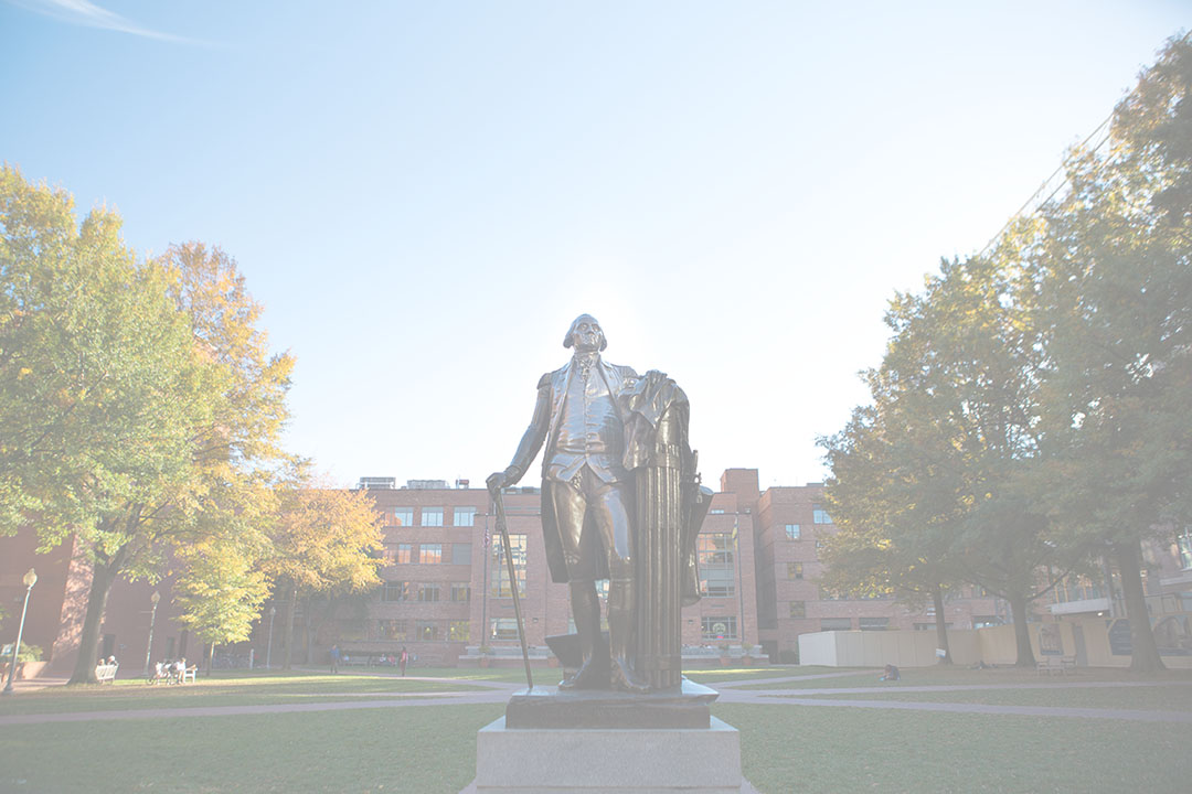 George Washington statue in University Yard in Washington, DC with trees and buildings in the background