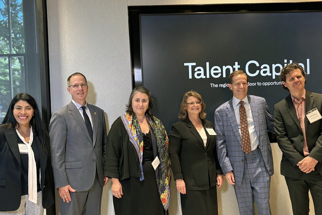 Dr. Ximena Gates Hartsock, Dr. Paul Kihn, Dr. Ina Gjikondi, Dr. Andrew Flagel, and Kyle Detrich pose in front of Talent Capital sign.