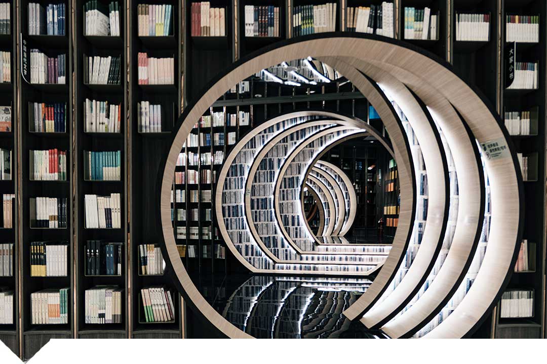 Books on shelves with spiral bookcase