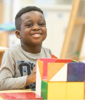African American boy with building toy on 
