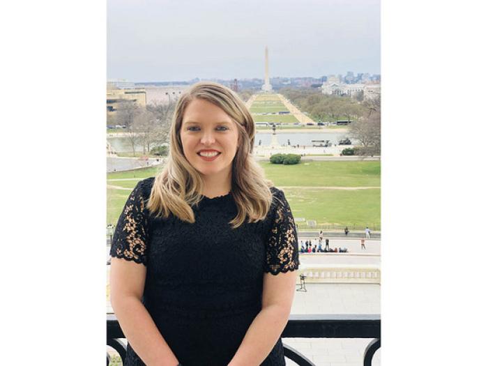 Emily Berret with the Washington Monument and reflecting pool behind her