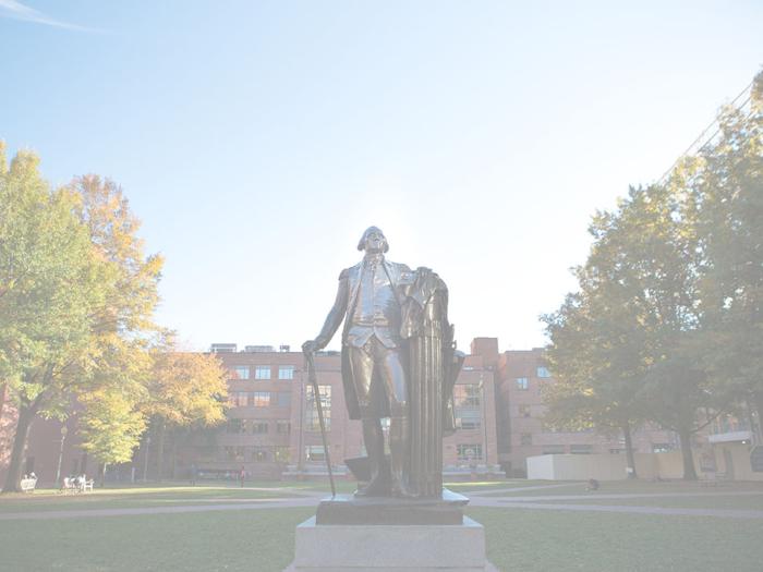 George Washington statue in University Yard in Washington, DC with trees and buildings in the background