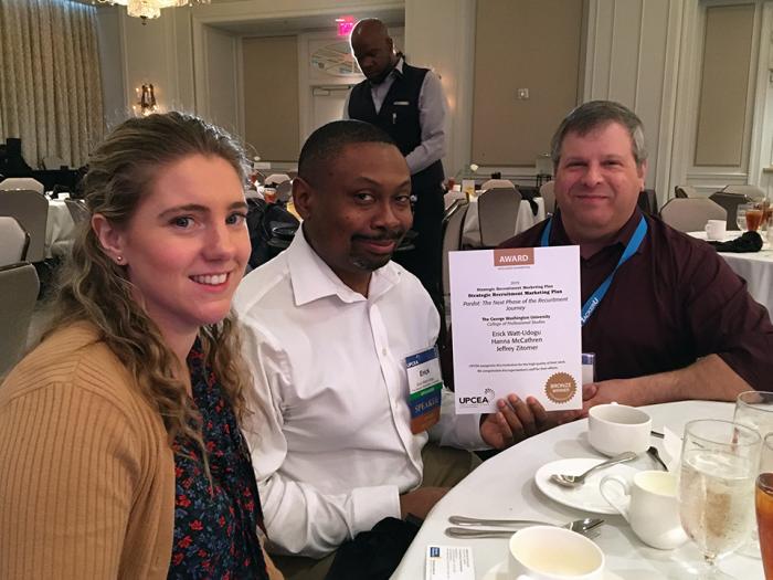 CPS marketing team holding award certificate at lunch in ballroom