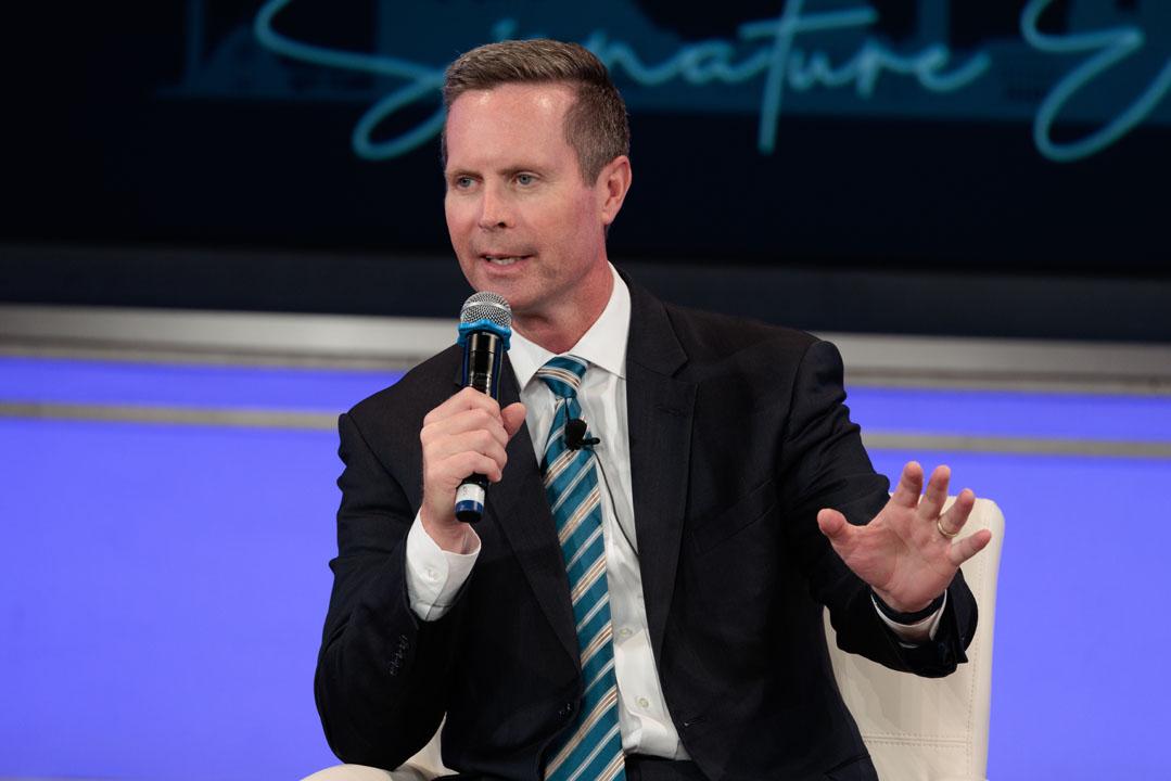 Rodney Davis sitting and speaking into a microphone