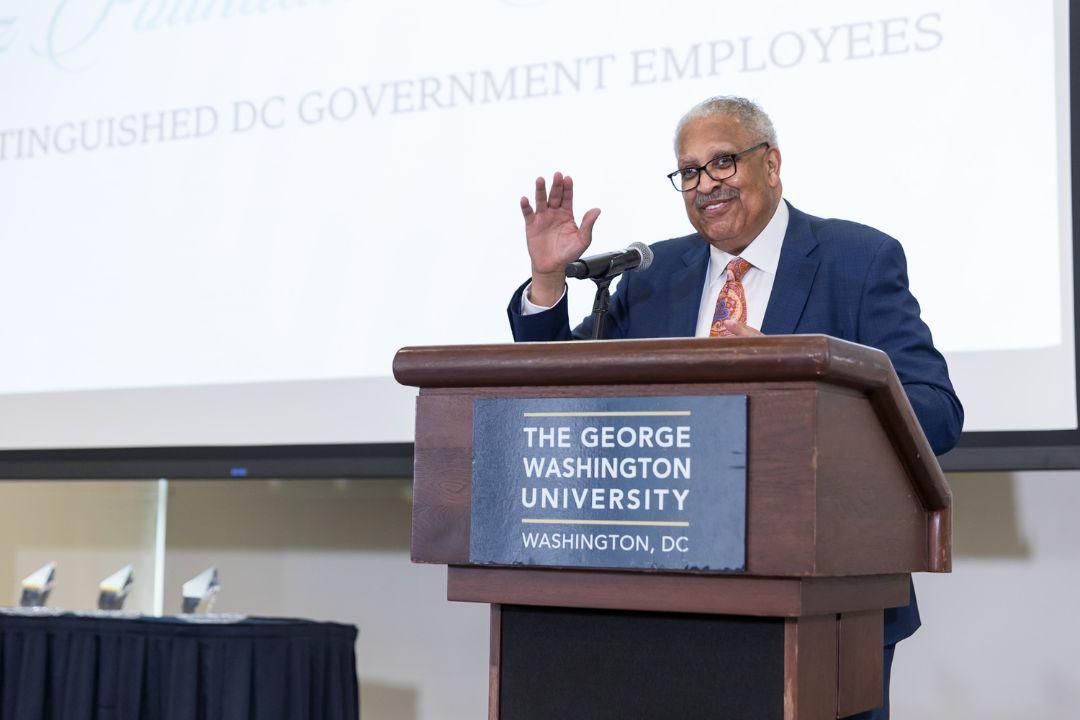 James Robinson speaking at a podium