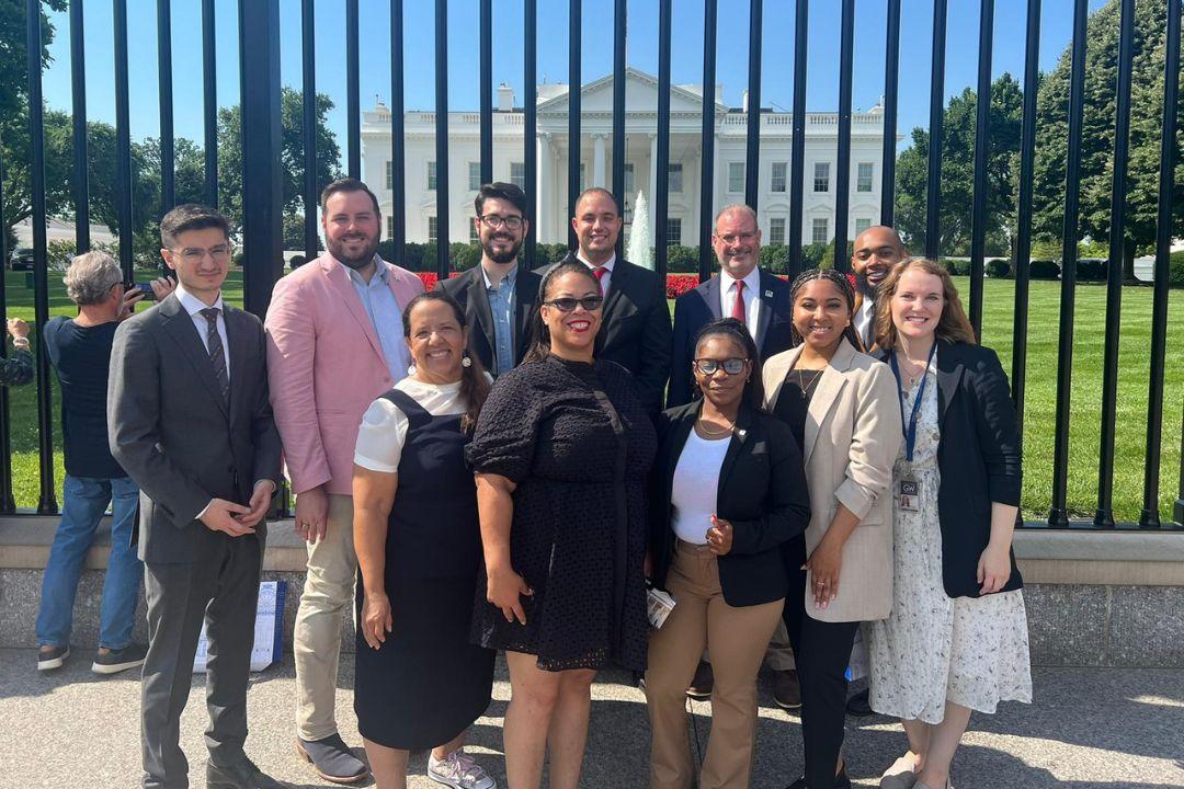 Group of students posing outside the White House gates