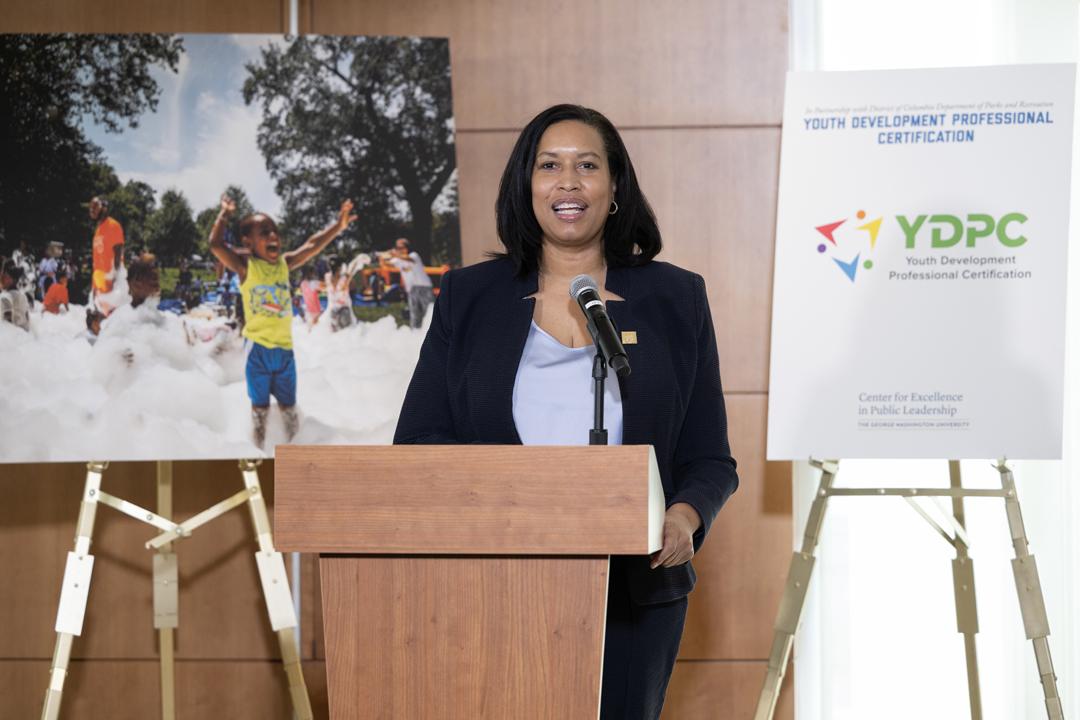 DC Mayor Muriel Bowser speaking at a podium