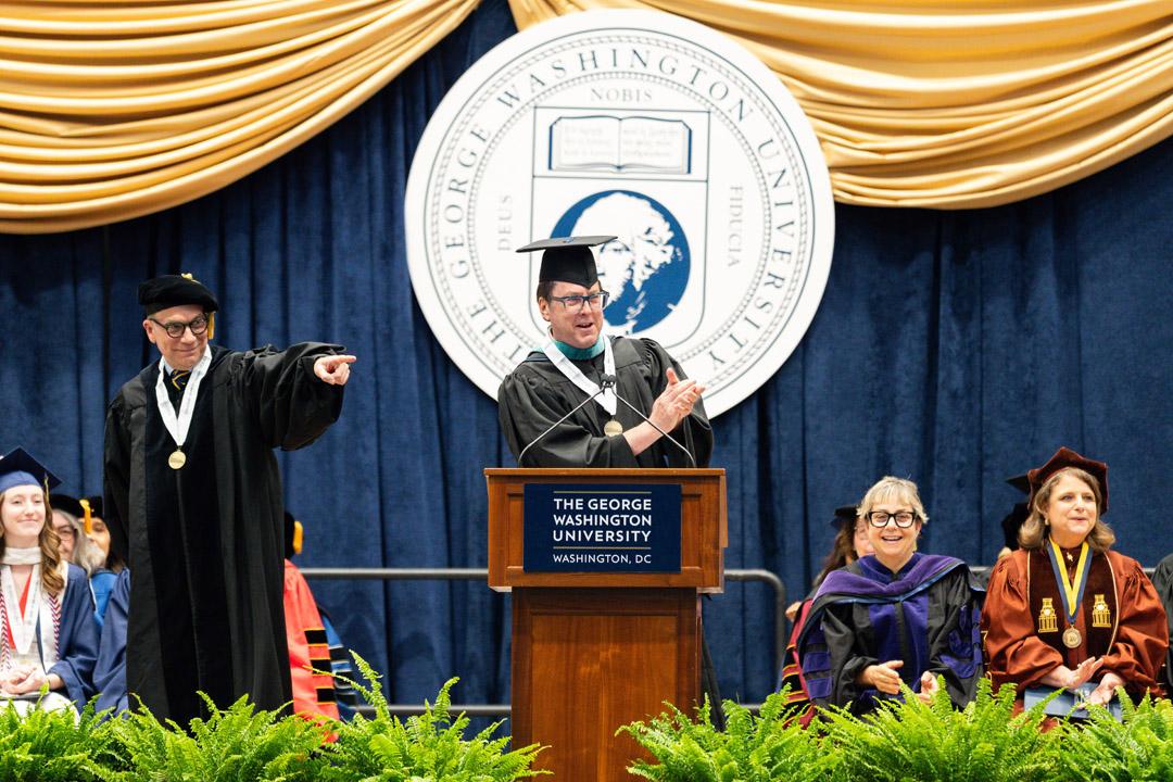 Gregory Britton and John Warren stand onstage