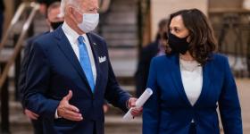 Joe Biden and Kamala Harris, both wearing blue suits and face masks