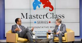 Rep. Will Hurd and Steven Billet sitting onstage in front of MasterClass series screen