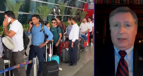 Scott White media interview and large line of people at airport with suitcases