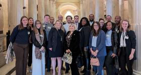 Group of GSPM students posing with Emily Berret in the U.S. Capitol Building